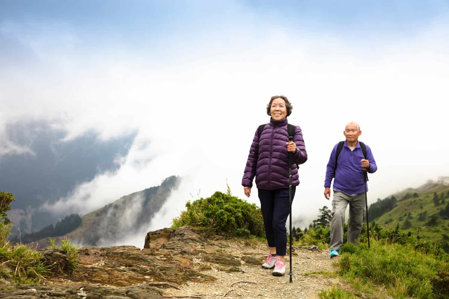 Retired couple hiking in the mountains