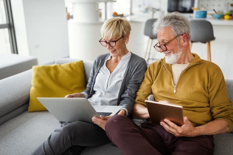 Retired couple reading on the couch