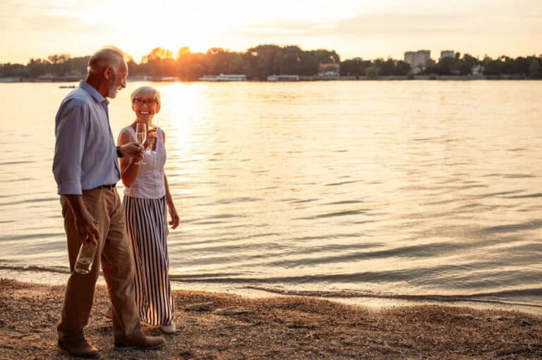 Retired couple walking on beach