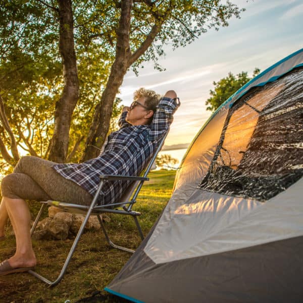 Retired woman napping by tent