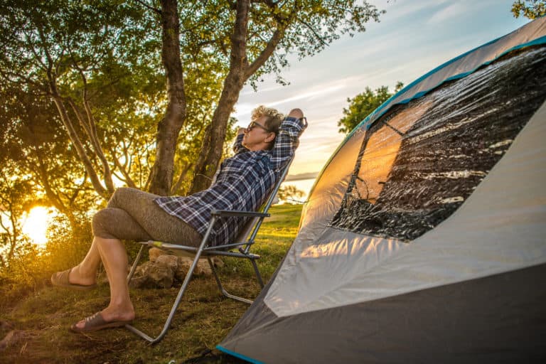 Retired woman napping by tent